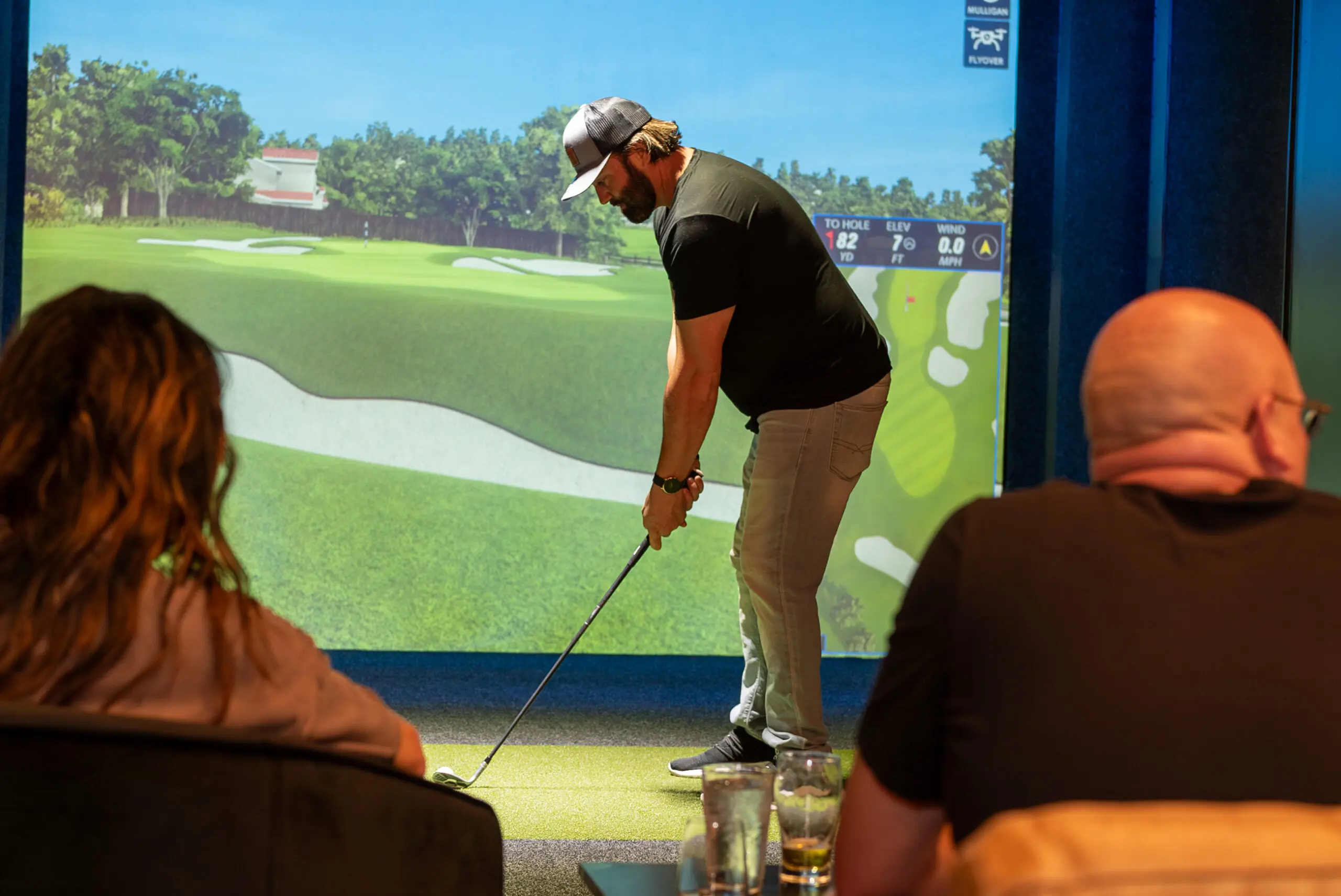 A man using the Full Swing Golf Simulator