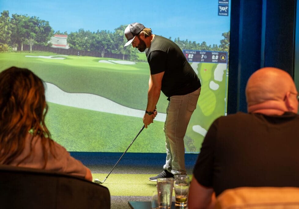 A man using the Full Swing Golf Simulator