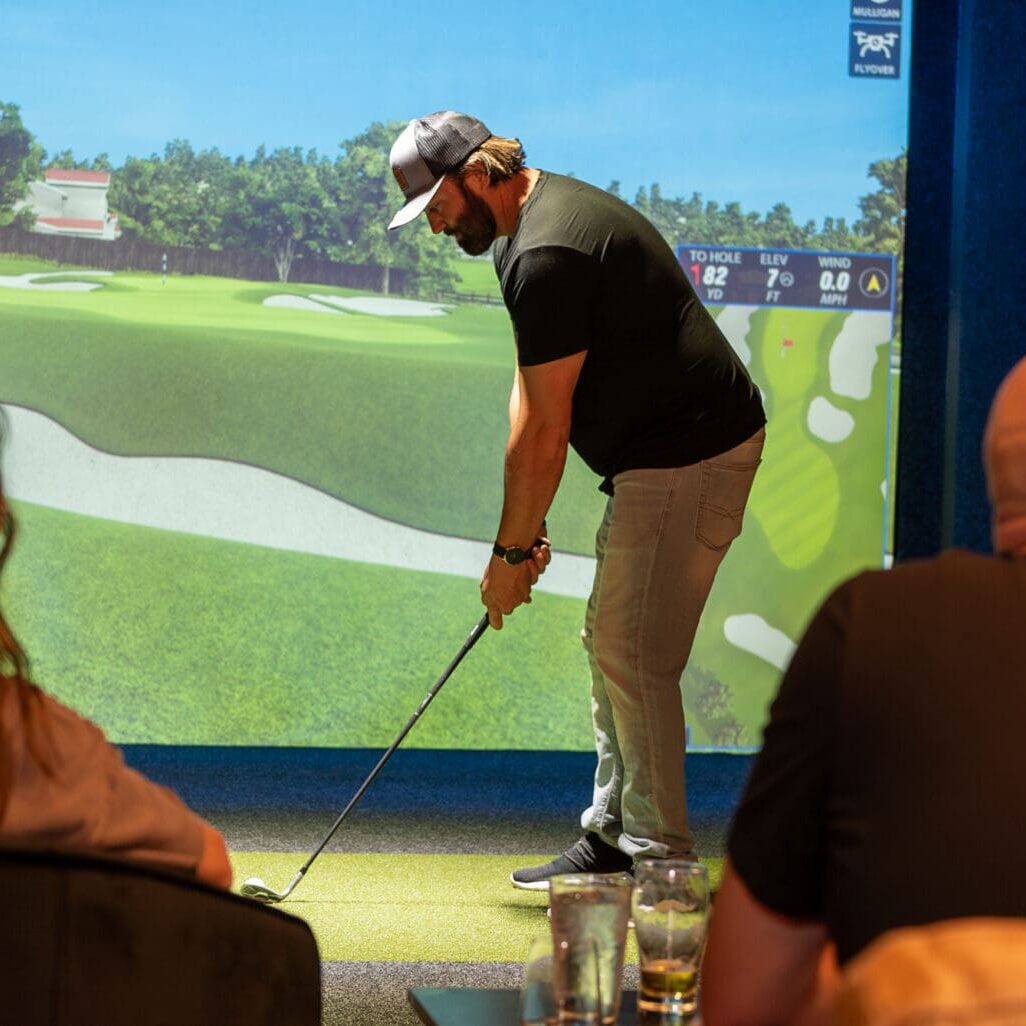 A man using the Full Swing Golf Simulator